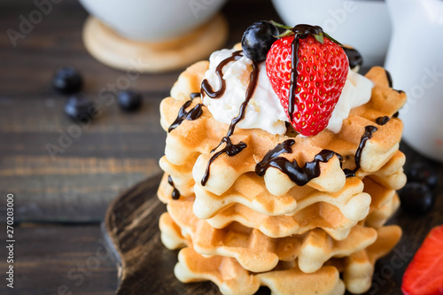 Fotografie Waffles with berries and whipped cream