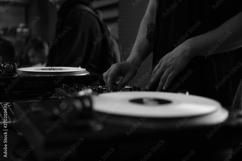 Dj in action, mixing tracks, create music at the dark place on grayscale Dj in action, mixing tracks, create music at the dark place on grayscale