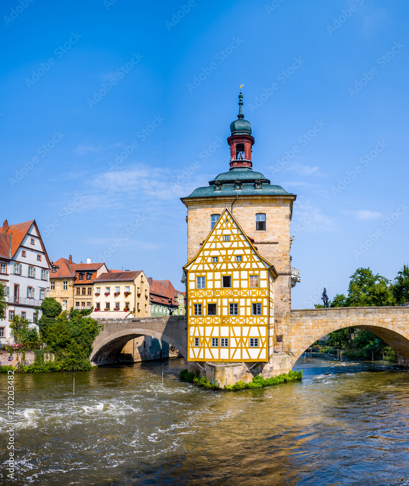 View of Old Town Hall of Bamberg (Altes Rathaus) with two bridges over the Regnitz river.
