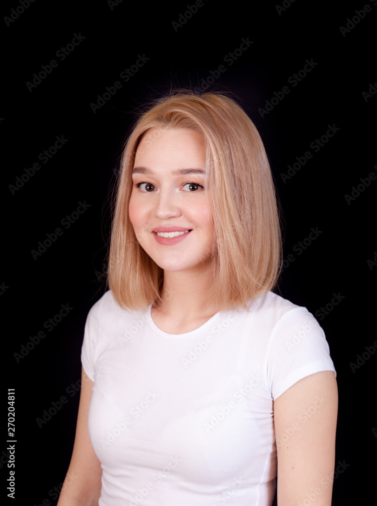 Young laughing blonde woman portrait in white t-shirt on black background Young laughing blonde woman portrait in white t-shirt on black background
