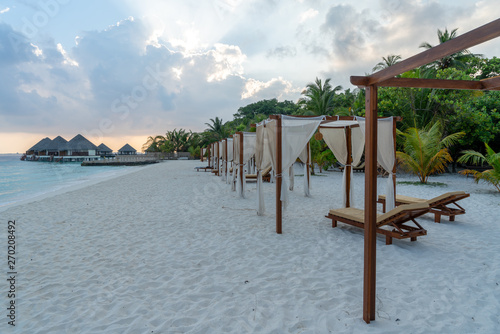 Wallpaper Mural beach view with loungers, water villas and palmes Torontodigital.ca