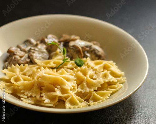 pasta Farfalle with mushrooms, cream sauce and cheese (main dish) snack. food background. top