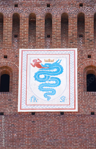 Milan, Italy: the biscione, an azure serpent in the act of consuming a human, the emblem of the House of Visconti and of the city from the 11th century, on the Filarete Tower of the Sforza Castle photo