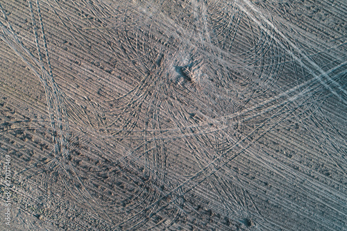 traces of the wheels in the field after harvest. view from above