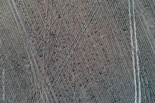 traces of the wheels in the field after harvest. view from above