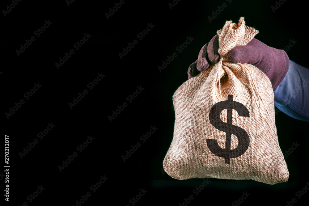 money bag with US dollars isolated on black background, Stock image