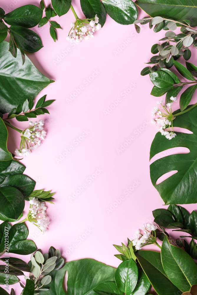 Fototapeta premium Tropical green leaf frame on pink background with copy space. Flat lay. Top view. Summer or spring nature concept