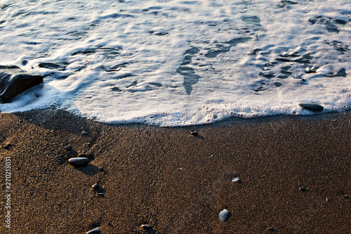 The soft ocean wave on sandy beach. Ocean wave close up with copy space for text. Background image.