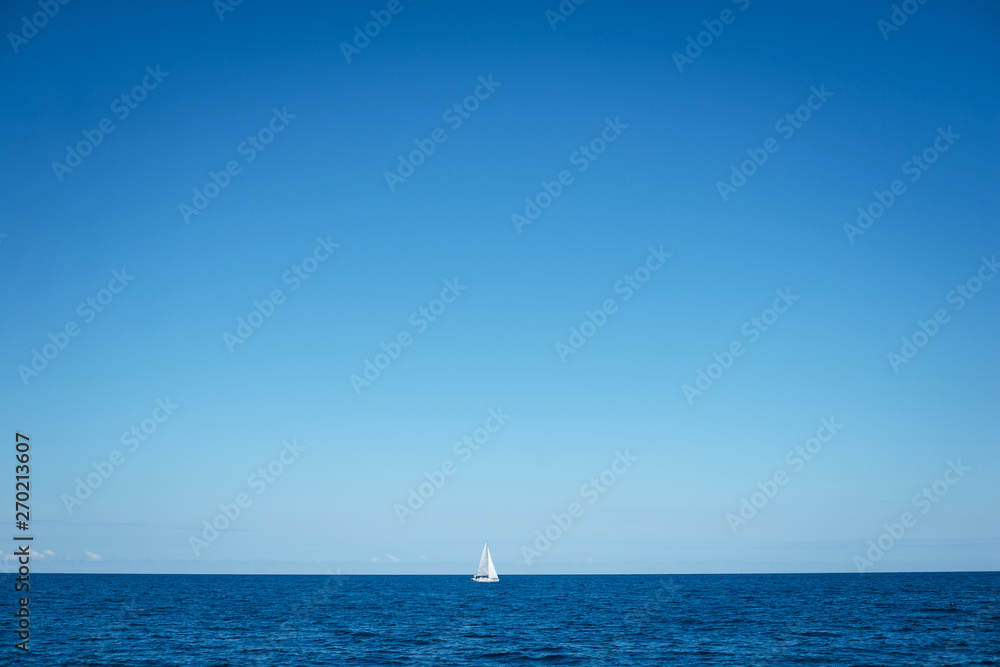 Alone boat at an open sea in the sunny weather day, Greece. Free space for text or logo