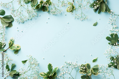 Small white gypsophila flowers on pastel blue background. Women's Day, Mother's Day, Valentine's Day, Wedding concept. Flat lay. Top view. Copy space