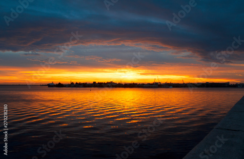 unusually bright sunset with dark clouds