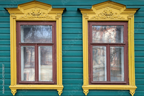 wooden windows with carved platbands.