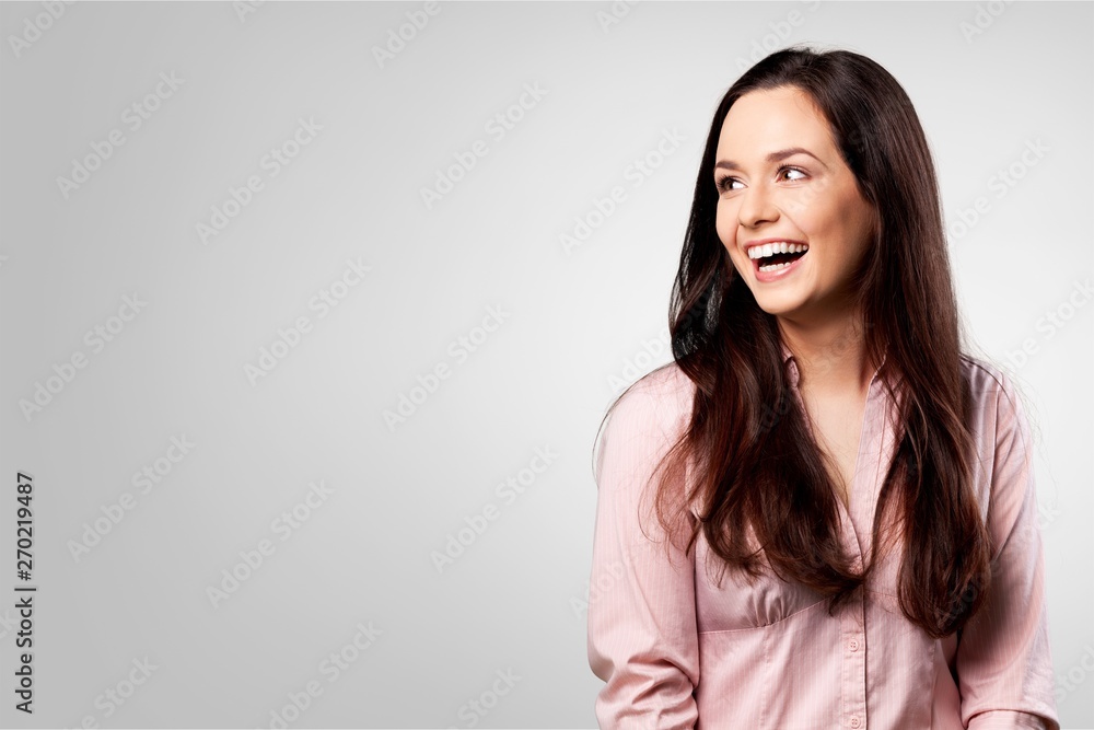 Portrait of pretty young woman in pink shirt on grey background Portrait of pretty young woman in pink shirt on grey background
