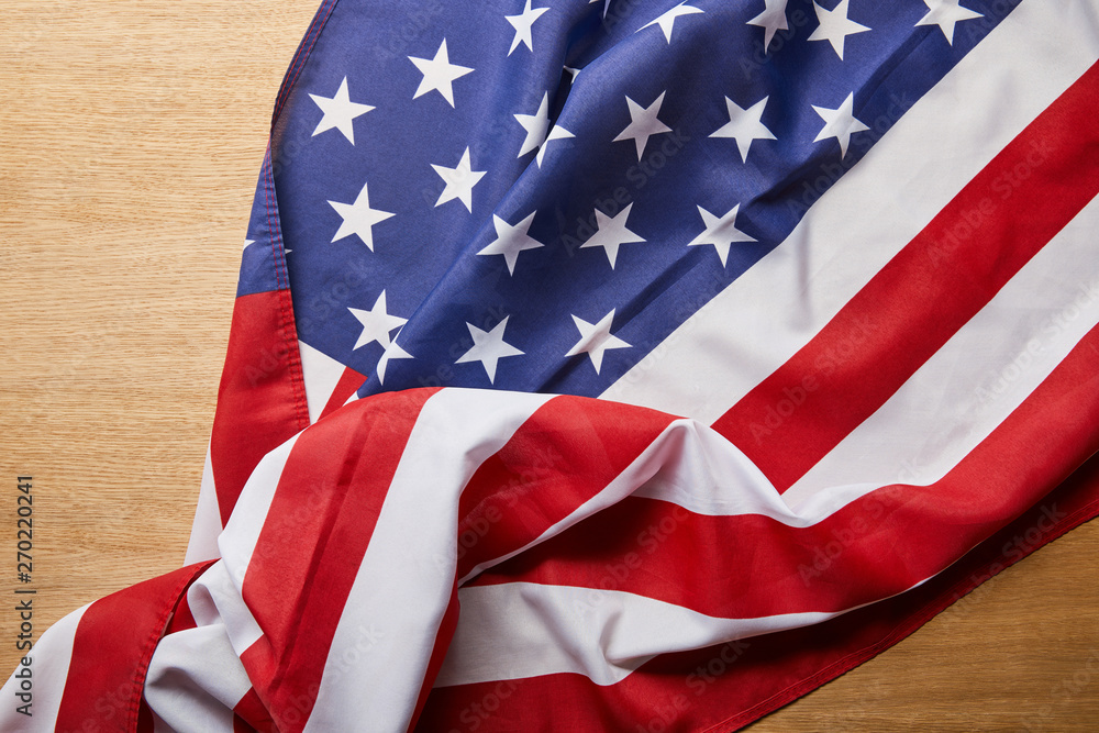 top view of crumpled american flag on wooden surface