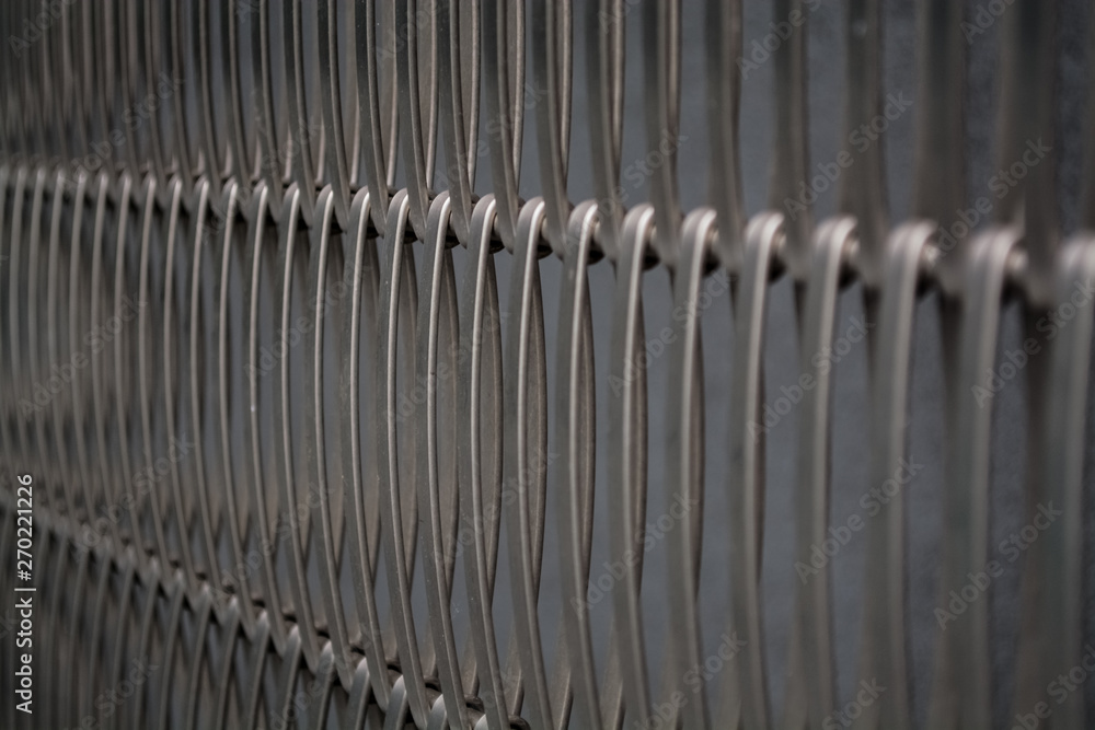 Background or texture from a gray monophonic fence from metal the bound wire in several rows. Background or texture from a gray monophonic fence from metal the bound wire in several rows.
