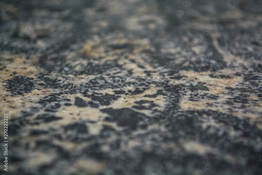 Background or texture from a gray stone with round spots and stains. Natural material. Glossy surface. Background or texture from a gray stone with round spots and stains. Natural material. Glossy surface.