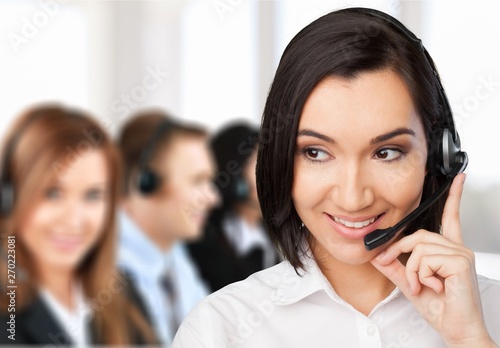 Young woman with headphones, call center or support concept
