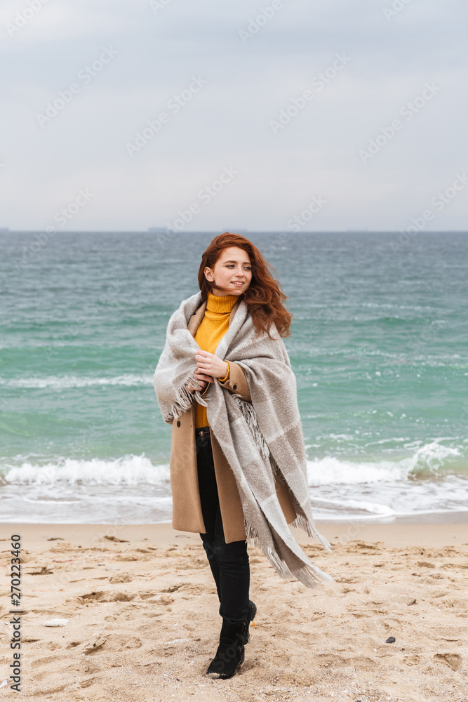 Lovely young redhead woman wearing autumn coat Lovely young redhead woman wearing autumn coat