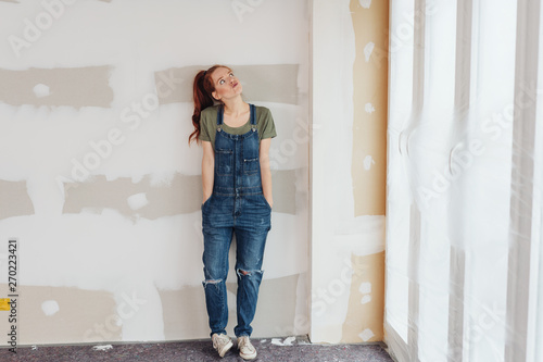 Принти на полотні Cute young woman in denim dungarees
