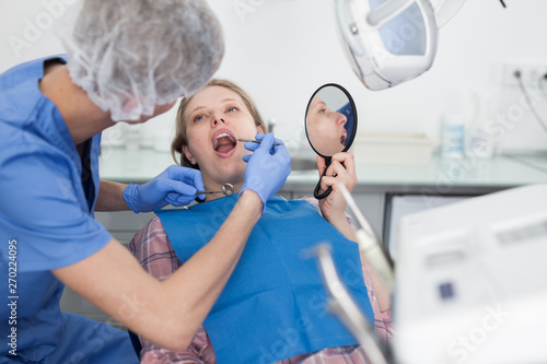Young woman on dental checkup in modern dentist office