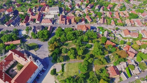  View down to Benedictine Monastery of Tihany (Tihany Abbey) and red roof houses in Hungary from aerial perspective photo