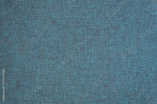Light blue background from a textile material. Fabric with natural texture. Cloth backdrop