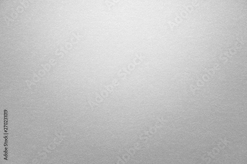 Abstract grey glossy paper texture background or backdrop. Empty gray cardboard or shiny paperboard for decorative design element. Simple grainy textured surface for journal template presentation photo