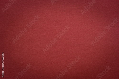 Abstract red glossy paper texture background or backdrop. Empty wrapping paper or shiny paperboard for decorative design element. Grainy surface for christmas holiday or Chinese new year concept