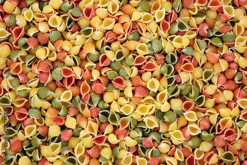 Принти на полотні Italian conchiglie tricolour pasta forming an abstract background