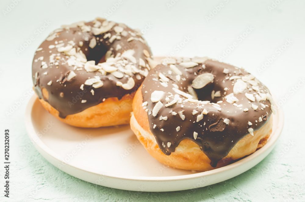 Donats. A plate with appetizing donata in chocolate glaze. Fresh pastries. Donats. A plate with appetizing donata in chocolate glaze. Fresh pastries.
