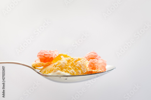 Healthy food concept. Flakes with grapefruit pieces in a spoon