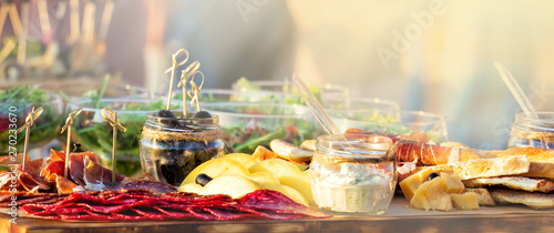 catering table set service with silverware and glass stemware at restaurant before party