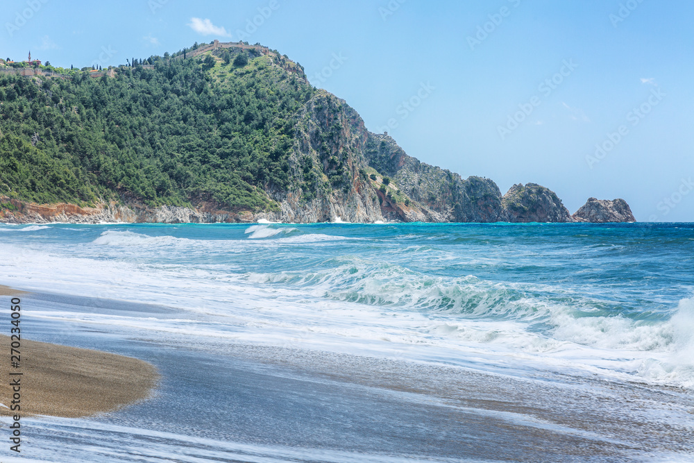 Beautiful view of the mountains and the sandy beach with turquoise sea