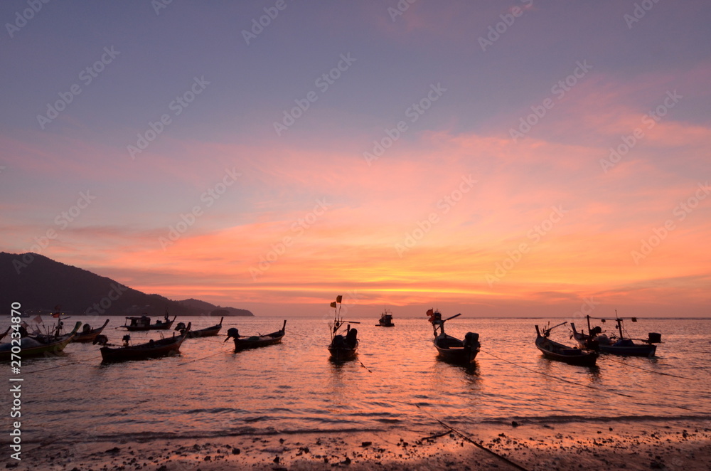 Silhouette of Thai Longtai Boat with beatuful sunset on nai yang beach phuket , thailand. 
