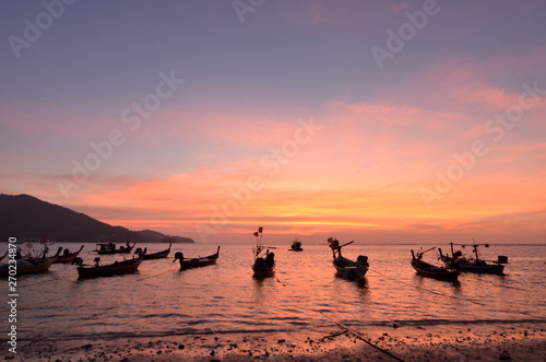 Silhouette of Thai Longtai Boat with beatuful sunset on nai yang beach phuket , thailand. 