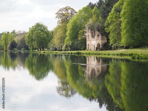 3.	Cobham, UK - April 2019 - Reflection Of Abbey Ruins In Water At Painshill Par, A Landscape Garden In, Surrey, UK 