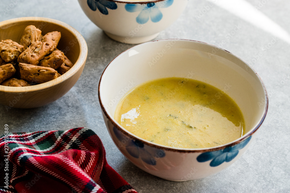 Homemade Zucchini and Carrot Soup with Crispy Bread at Lunch Table. Homemade Zucchini and Carrot Soup with Crispy Bread at Lunch Table.