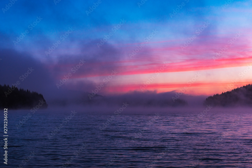 Stunning image of the foggy lake. Dramatic morning sunrise scene. 