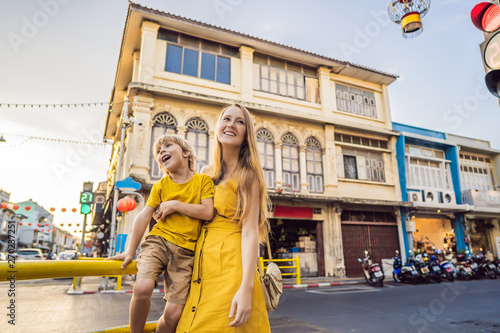 Mom and son tourists on the Street in the Portugese style Romani in Phuket Town. Also called Chinatown or the old town. Traveling with kids concept