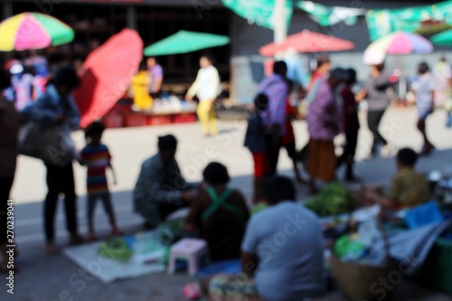 Female villagers bring vegetables for sale in the roadside market in the morning. Take blurred photos