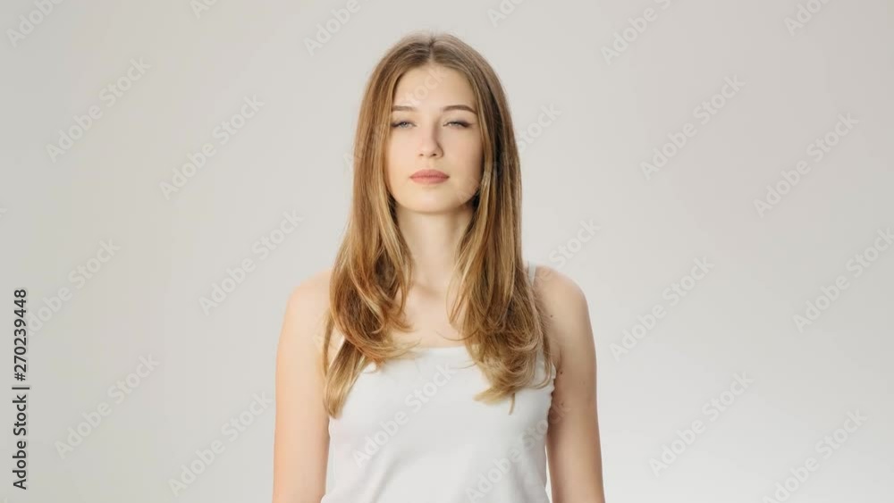 Sad and serious beautiful lady with the problem on the white background slow motion Sad and serious beautiful lady with the problem on the white background slow motion