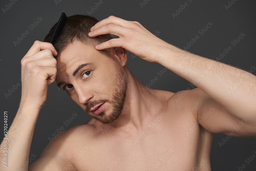Portrait of handsome bearded young man after having shower looking at camera Portrait of handsome bearded young man after having shower looking at camera