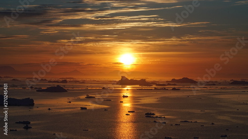 Sunset on icebergs in Arctic Ocean