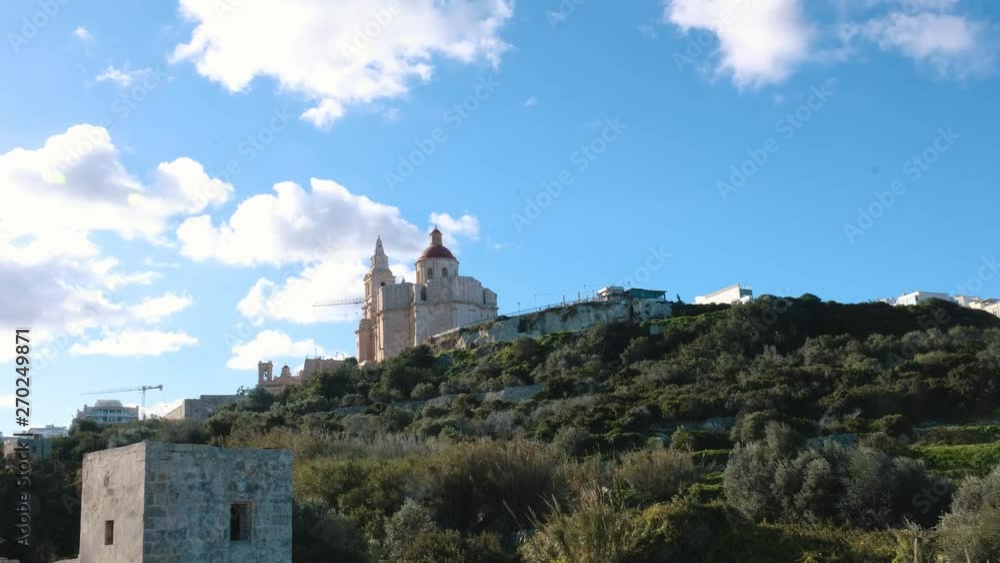 Low angle time lapse video showing the Church of Our Lady of Pompei in the town of Marsaxlokk in Malta in sunlight with high passing clouds. Low angle time lapse video showing the Church of Our Lady of Pompei in the town of Marsaxlokk in Malta in sunlight with high passing clouds.
