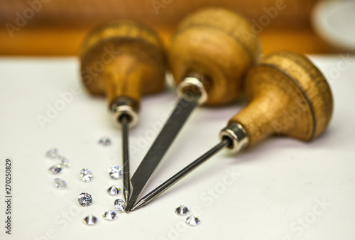 Jewelry production. Tool for fixing diamonds on a white background