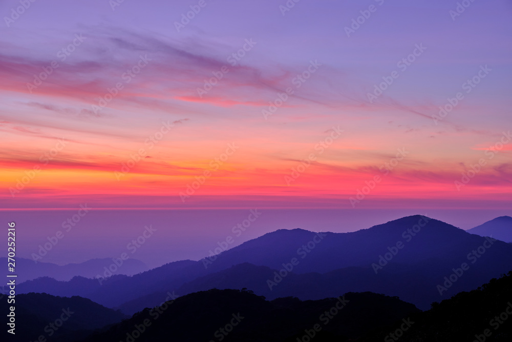 Twilight light pink and purple colors beautifully. reflect the views Mountains and fog in the morning. Khao Jed Yod, Trang in Thailand.