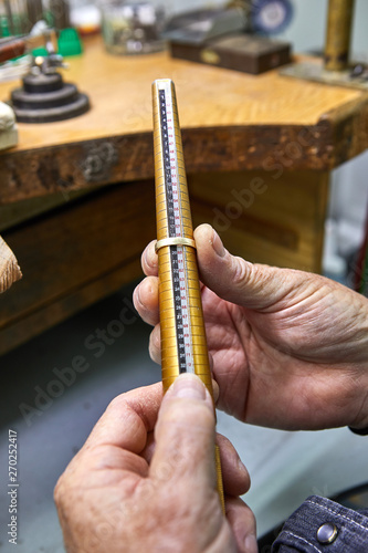 Jewelry production. The jeweler makes a gold ring. The process of measuring the ring