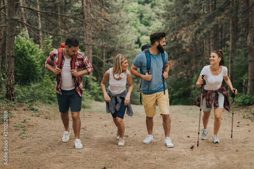 Happy young group hiking to...