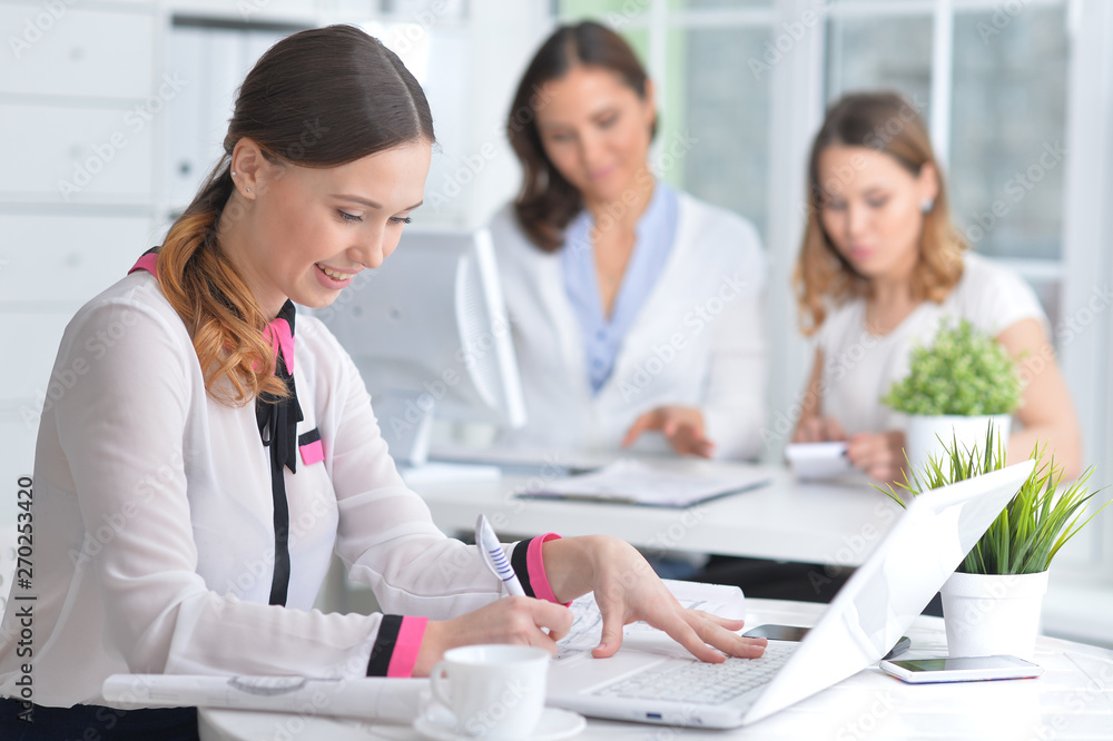 Fototapeta premium Portrait of young women working in modern office