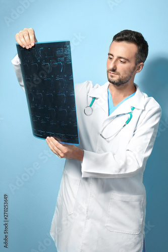 Male doctor with MRI scan o...
